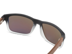 Sunglasses with brown gradient lenses and wooden arms on a white background